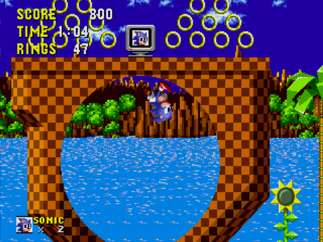 Sonic the Hedgehog - Sonic powers through a loop in Green Hill Zone.