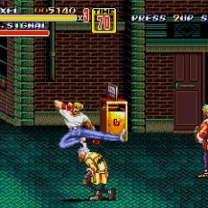Streets of Rage 2 screen shot of Axel jump kicking an enemy in an alley.